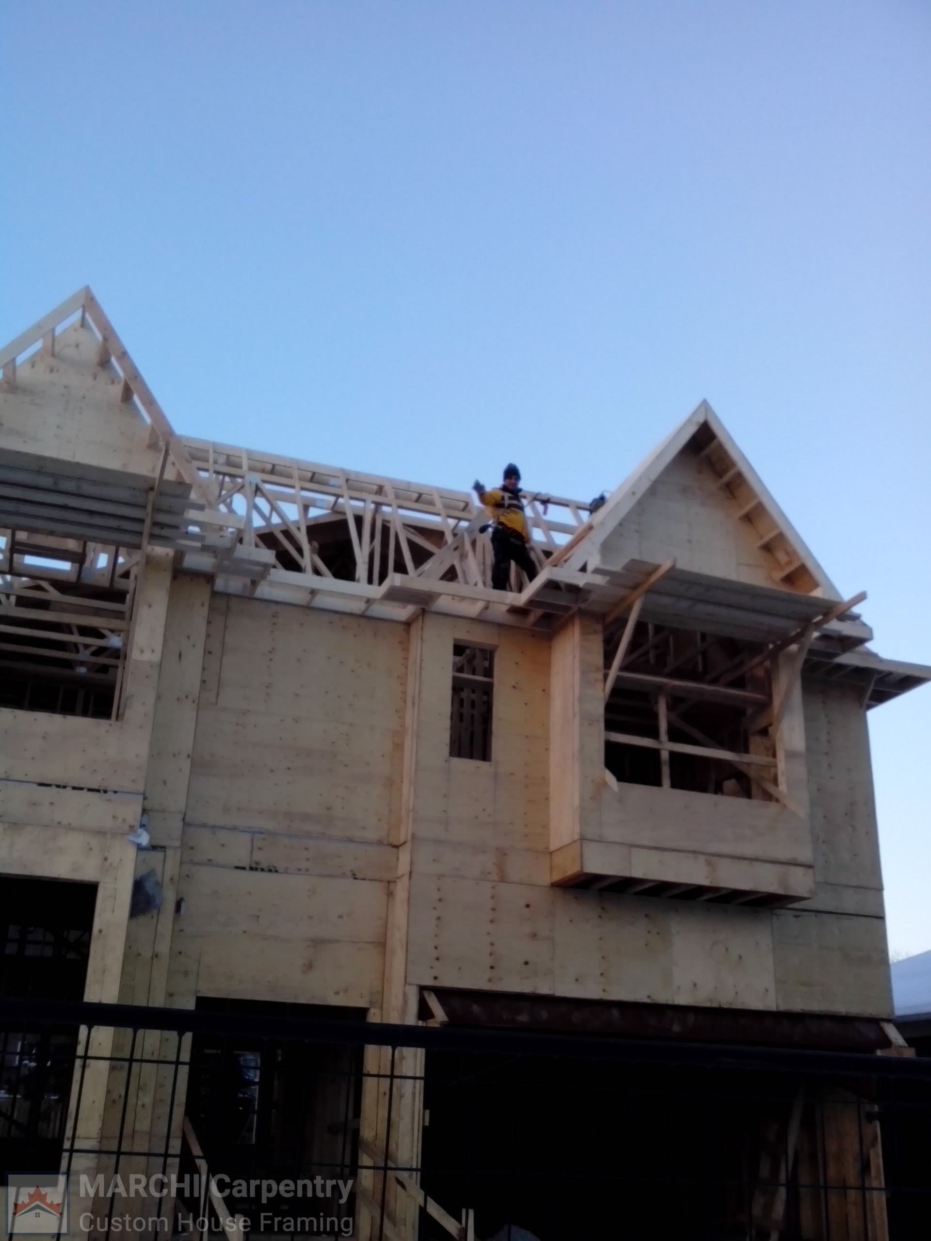 Marchi Carpentry crew framing the roof of a custom home